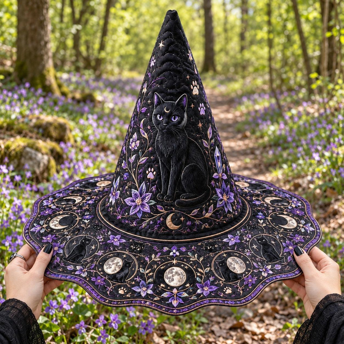 Violet Cat Witch Hat held by witch hands outdoors in natural sunlight
