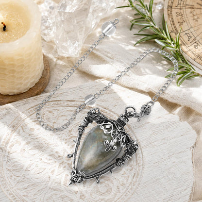 Labradorite-S water drop pendulum locket on a bright Pagan ritual altar