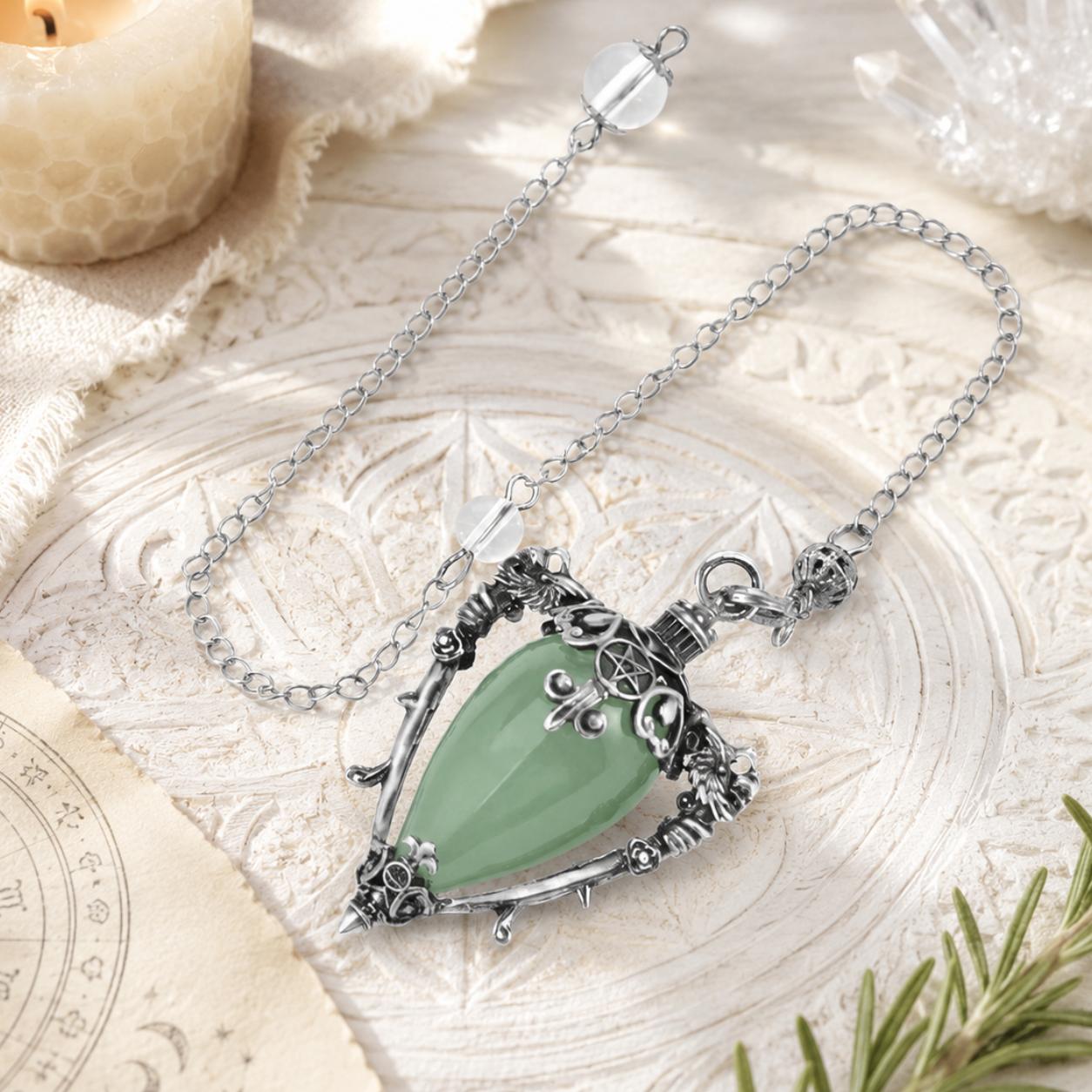Aventurine-S water drop pendulum locket on a bright Pagan ritual altar