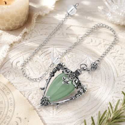 Aventurine-S water drop pendulum locket on a bright Pagan ritual altar