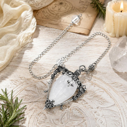 White Crystal-S water drop pendulum locket on a bright Pagan ritual altar