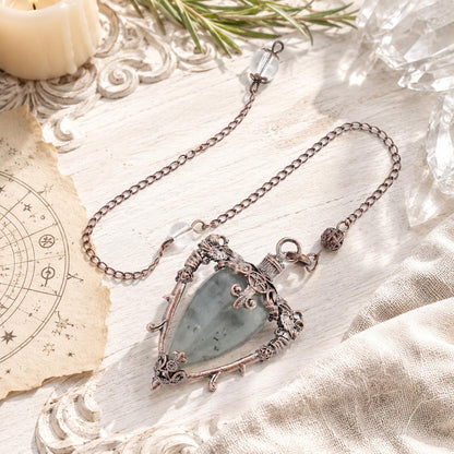 Labradorite water drop pendulum locket on a bright Pagan ritual altar