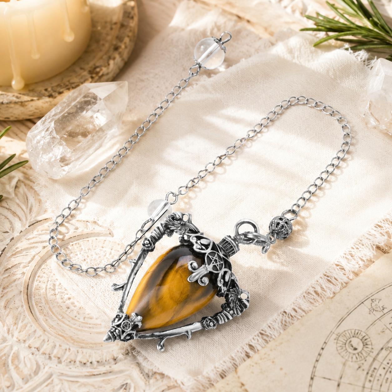 Tiger eye water drop pendulum locket detail on a bright Pagan altar