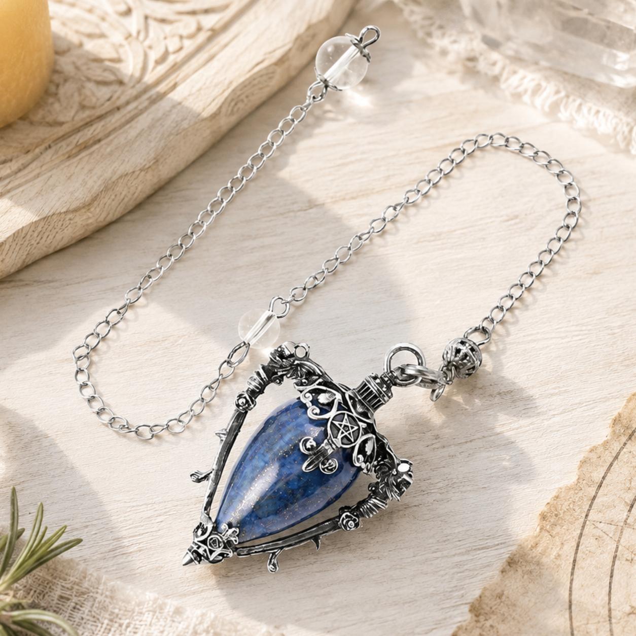 Lapis-S water drop pendulum locket on a bright Pagan ritual altar