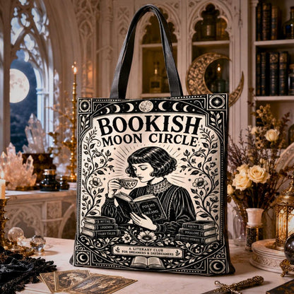 Gothic witchy tote bag printed with "Bookish Moon Circle" text, "A Literary Club for Dreamers & Daydreamers", and an art nouveau illustration of a woman reading with a teacup and stacked books.