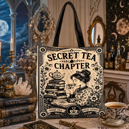 Gothic witchy tote bag printed with "Secret Tea Chapter" text, "Good Tea, Great Stories", and an art nouveau illustration of a woman drinking tea beside stacked books and a teapot.