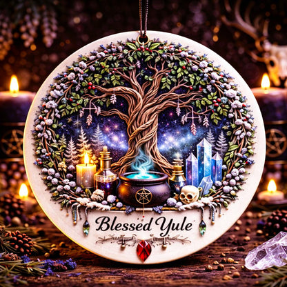 Round ceramic Yule ornament with a Tree of Life, glowing cauldron, crystals, and "Blessed Yule" text.