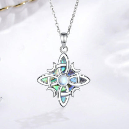 Sterling silver Witch Celtic Knot necklace with iridescent abalone inlay and a central moonstone, on an 18-inch chain.