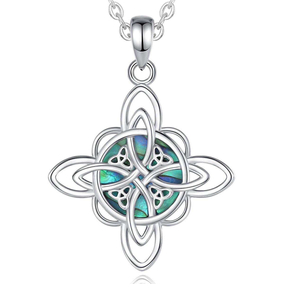 Sterling silver Witch Knot necklace with an iridescent abalone shell center, symbolizing protection and balance.
