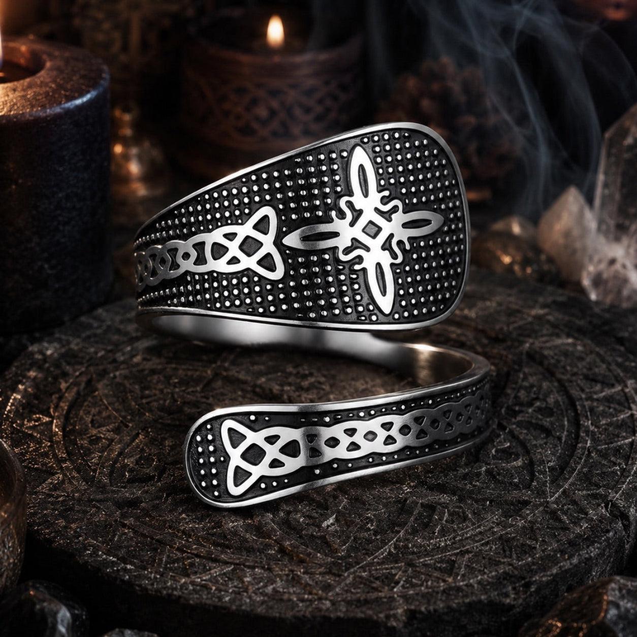 Silver Witch Knot open ring on a carved dark stone altar with candlelight, showcasing Celtic trinity and endless knot design