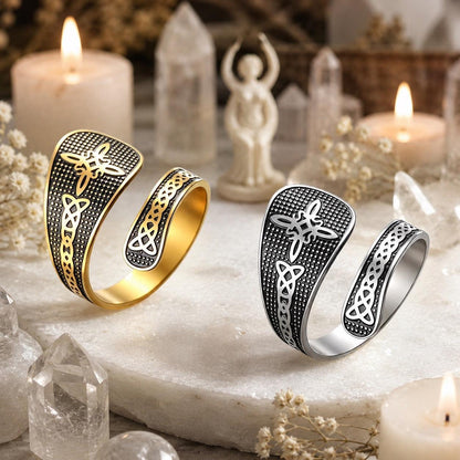 Gold and silver Witch Knot open rings side by side on a stone altar with candles, quartz crystals, and a goddess figurine