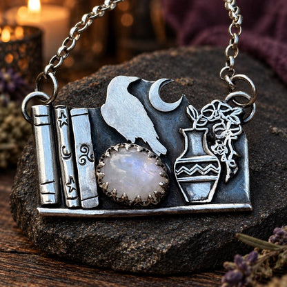 Raven bookshelf pendant necklace with moonstone, crescent moon, vase and books - wiccan jewelry