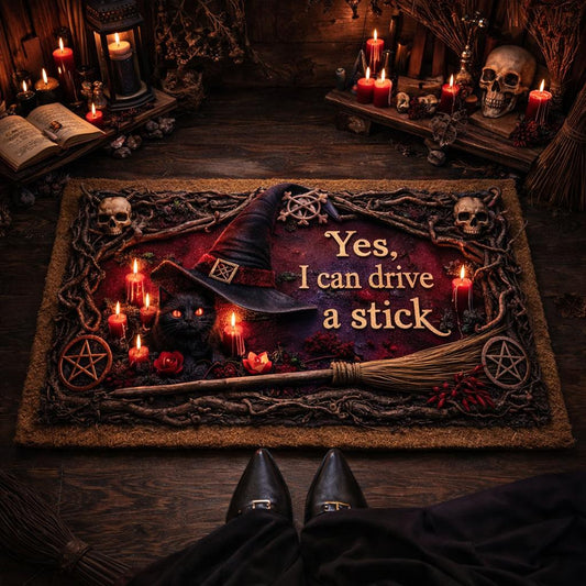 Witchy doormat with a black cat in a witch hat, skulls, candles, and "Yes, I can drive a stick" text.