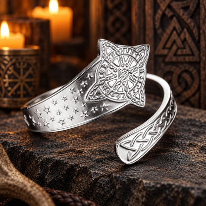 Celtic Witch Knot Ring with Triquetra & Rune Wheel Engraving in a dark pagan Viking altar setting, detailed polished metal finish