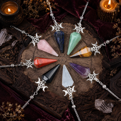 Eight Triple Moon crystal pendulums arranged on a candlelit Wiccan ritual altar