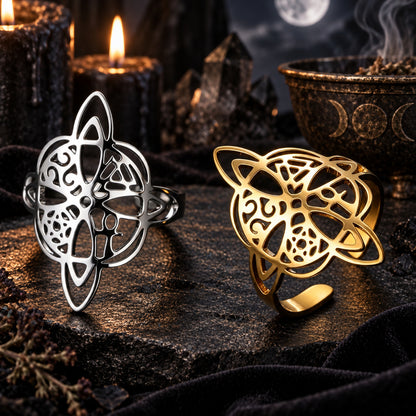 Gold and silver witch knot pagan rings on a dark altar.