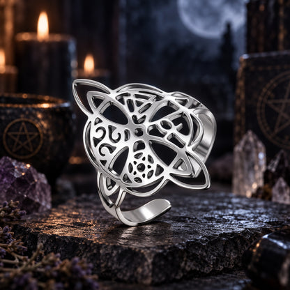 Silver witch knot ring with polished openwork symbols.
