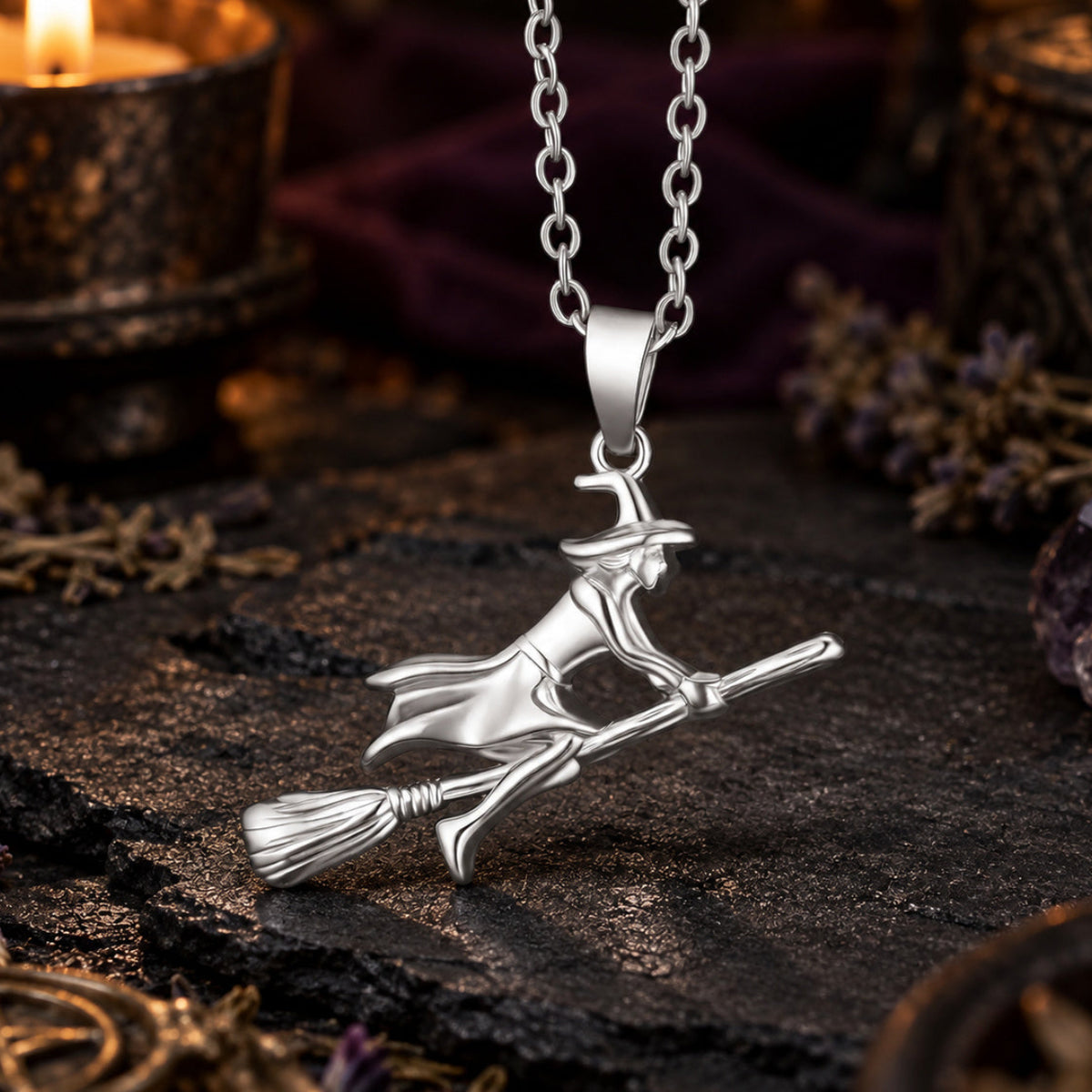 Silver Witch Riding Broom Necklace in a candlelit witchy altar scene, detailed polished pendant.