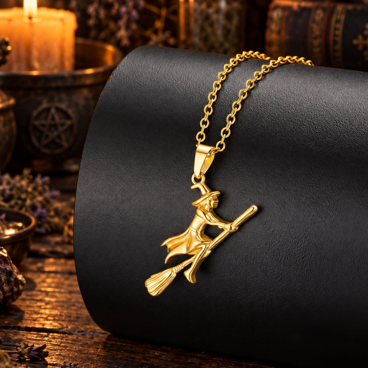 Gold Witch Riding Broom Necklace in a candlelit witchy altar scene, detailed polished pendant.