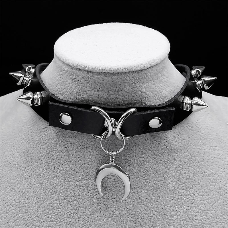 Black leather choker with silver spikes and a crescent moon pendant, perfect for a gothic witch look.