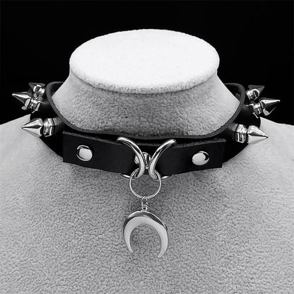 Black leather choker with silver spikes and a crescent moon pendant, perfect for a gothic witch look.