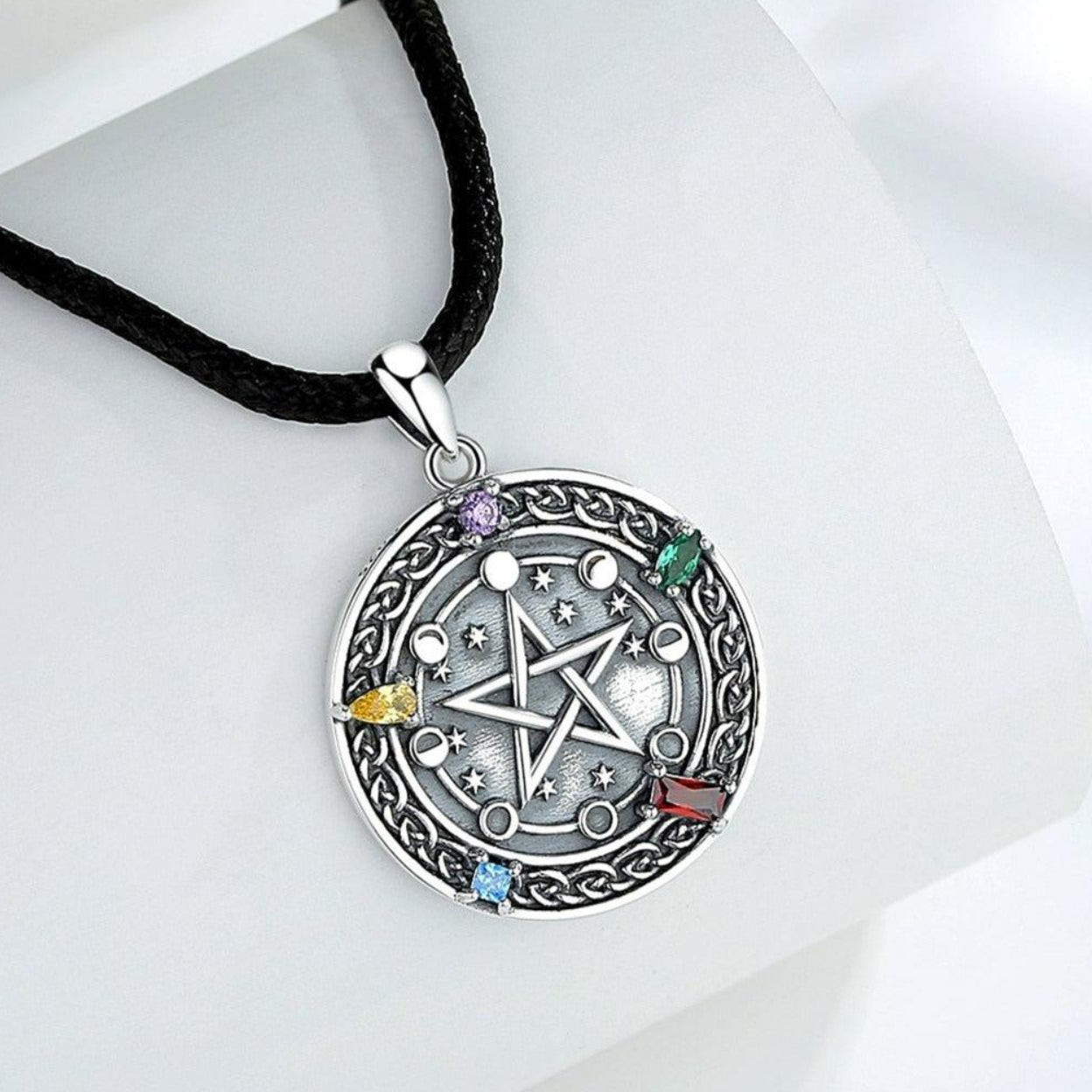 Sterling silver Moon phase Pentacle Necklace with colorful gemstones on a black cord.