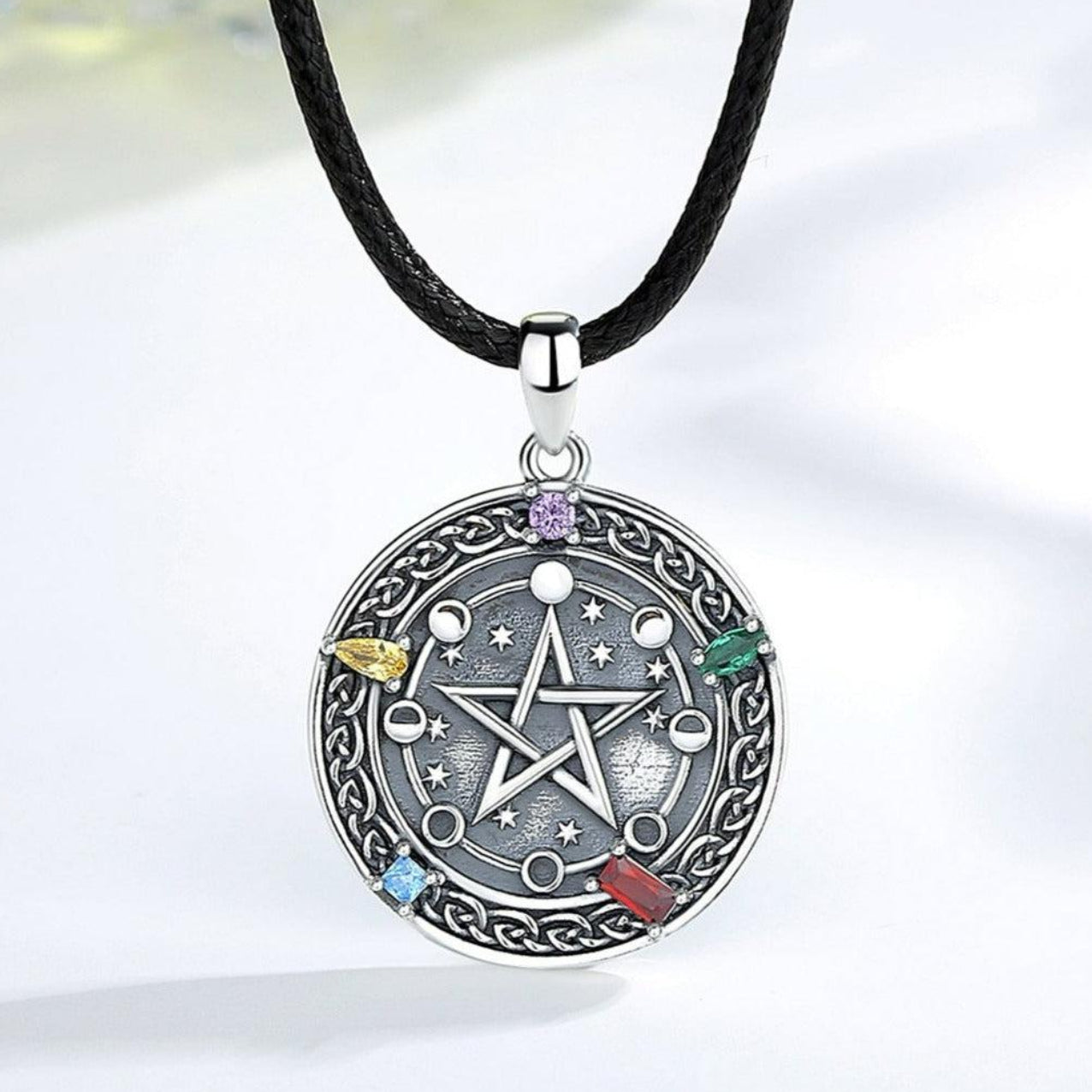 Sterling silver Moon phase Pentacle Necklace with colorful gemstones on a black cord.