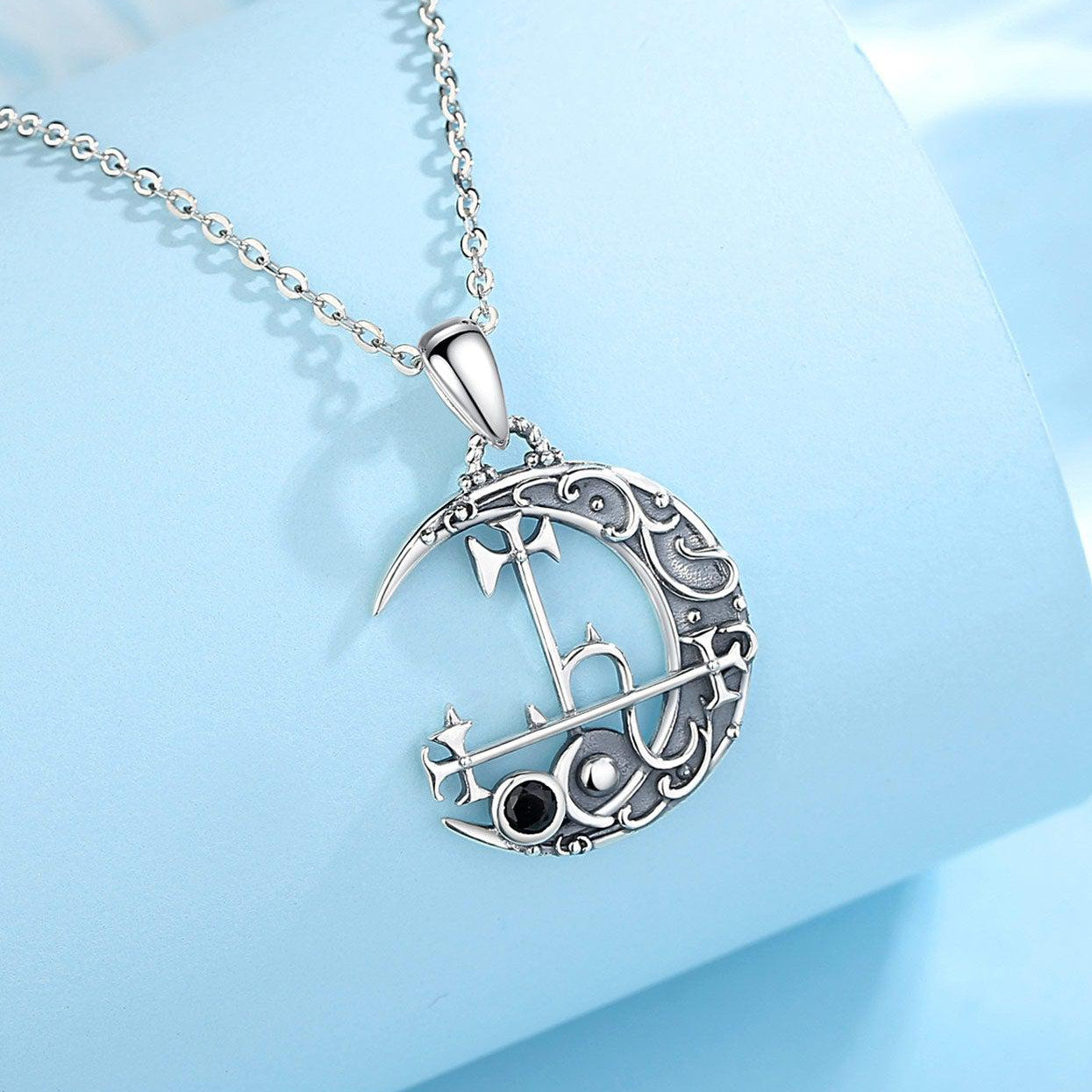 Sterling silver Lilith Moon necklace, 30x20mm pendant with intricate sigil design and black accent stone.