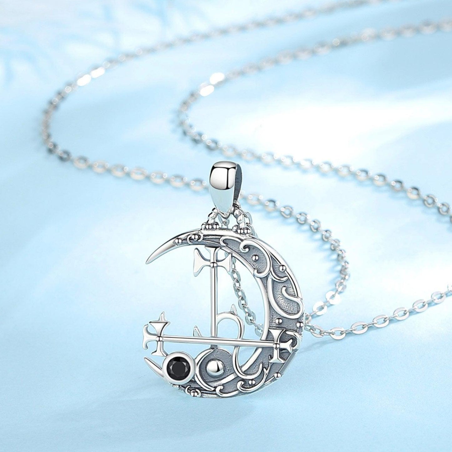 Sterling silver Lilith Moon necklace with intricate sigil design, black gemstone, and delicate chain.