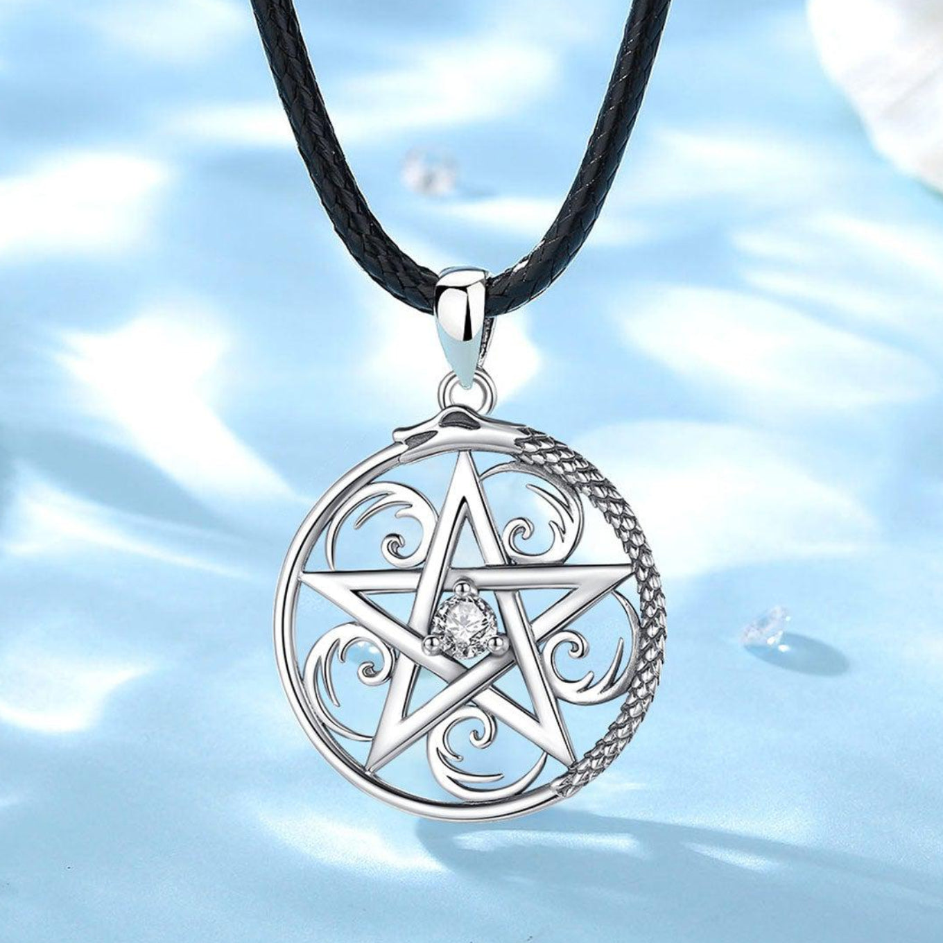 Sterling silver pentacle necklace with a sparkling cubic zirconia center and dragon ouroboros design on a black leather chain.
