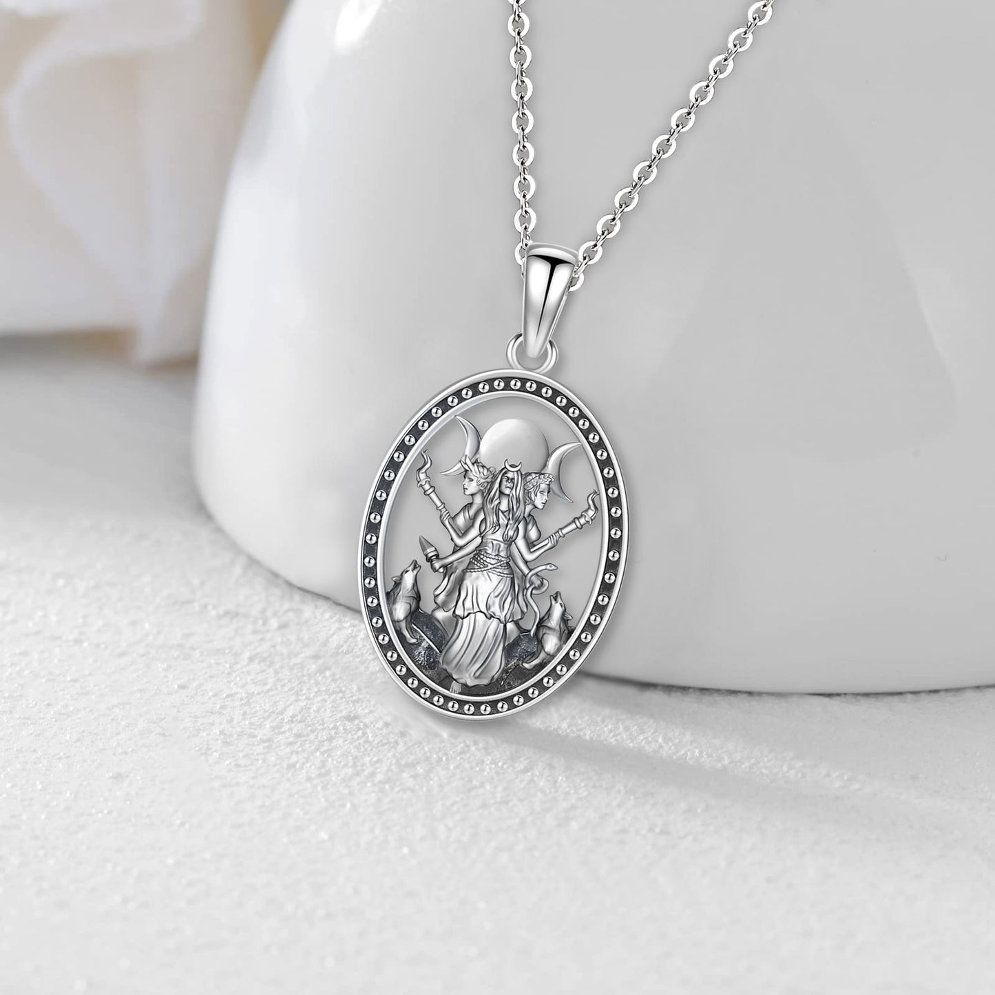 Elegant silver Triple Moon Goddess Hecate necklace, featuring an oval pendant with a detailed goddess figure.